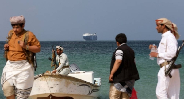 Houthi militants on a boat guarding the hijacked Galaxy Leader commercial ship
