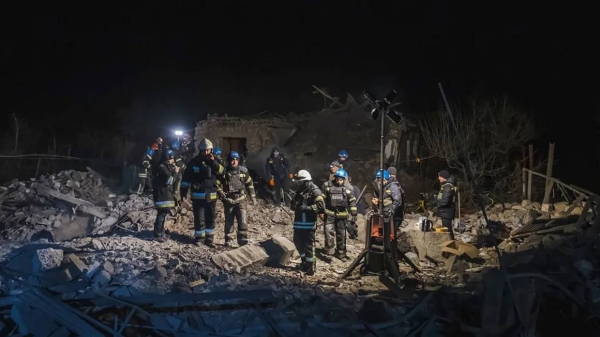 Ukrainian firefighters examine the site of Russia's missile attack that hit an apartment building in Pokrovsk, Ukraine, on Saturday, January 6