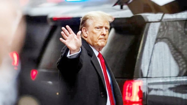 Donald Trump gestures to his supporters as he heads to court on Friday morning. — courtesy Reuters