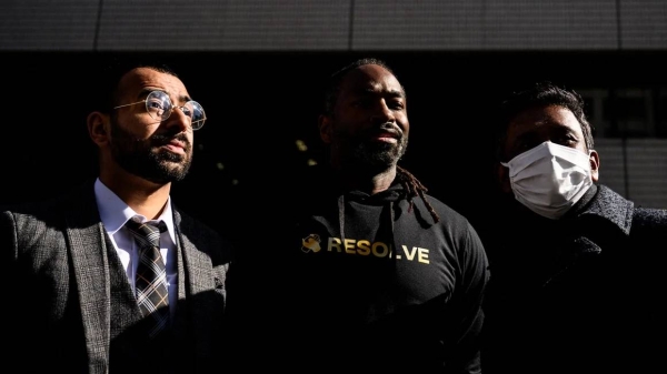 The three plaintiffs who filed a lawsuit against the Japanese government alleging racial profiling stand outside the Tokyo District Court on January 29, 2024