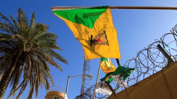 The Kataib Hezbollah militia group's flag flies at a protest outside the US Embassy in Baghdad, Iraq, in 2019