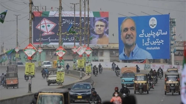 Election posters for the MQM-P (kite) and Jamaat-e-Islami (scales) parties are seen here in Karachi