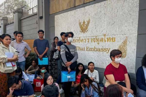 People stand in line for visas at the Thai Embassy in Yangon on February 16, 2024, after Myanmar's military government said it would impose military service