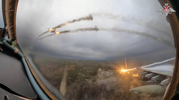 A Russian Su-25 warplane is seen from the cockpit of another such aircraft as they fire rockets on a mission over Ukraine