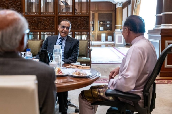 Malaysia’s Prime Minister Anwar Ibrahim holds talks with Sheikh Abdullah Saleh Kamel, president of the Islamic Chamber of Commerce, Industry and Agriculture, in Kuala Lumpur on Friday.