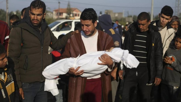 A Palestinian man holds the body of his four-year-old son, who is killed in the Israeli air strike in the Gaza Strip, Feb. 26