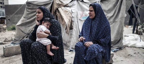 Two women and one child in front of their house of sorts in the heart of Gaza. Apart from their appalling living conditions, Gazan parents find themselves unable to meet their children’s basic needs such as food, health and housing. — courtesy WFP/Wissam Nassar