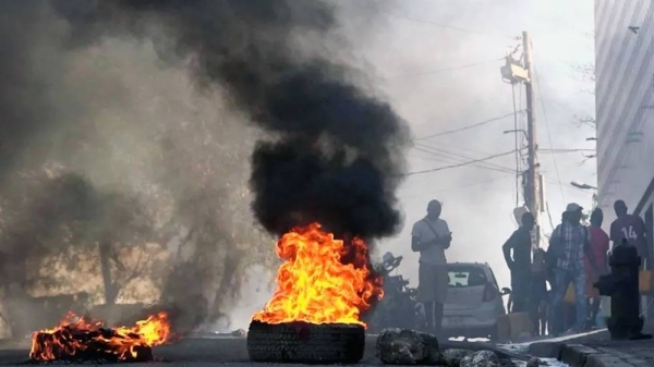 Tires were set on fire outside the main prison in the Haitian capital, Port-au-Prince. — courtesy Getty Images