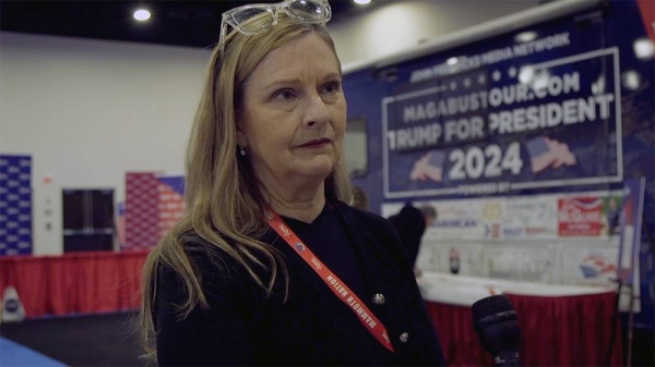 A Trump supporter is being interviewed at a MAGA rally.