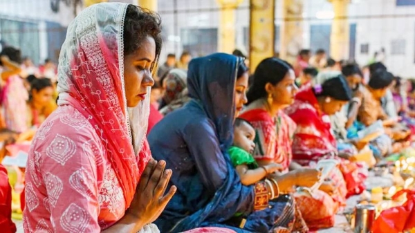 Hindu devotees sit together in a temple in Dhaka, Bangladesh. — courtesy Getty Images
