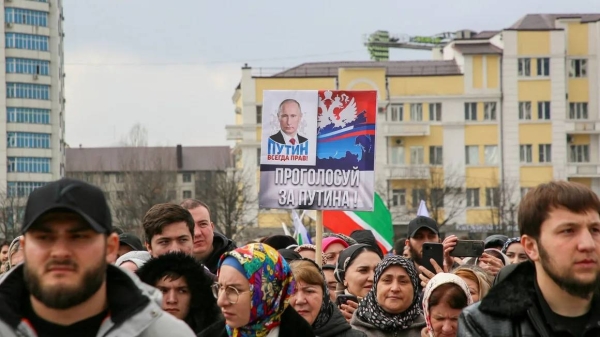 People including supporters of incumbent President Vladimir Putin take part in a procession organized on the occasion of the upcoming election, in the Chechen capital Grozny on March 10, 2024