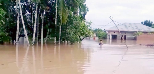 Rescuers, hampered by power outages, damaged bridges and roads blocked by thick mud, provide relief to people affected by the floods and landslides in the Indonesian province of West Sumatra.