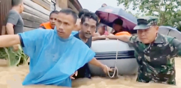 Rescuers, hampered by power outages, damaged bridges and roads blocked by thick mud, provide relief to people affected by the floods and landslides in the Indonesian province of West Sumatra.