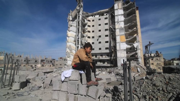 A Palestinian boy sits outside a residential building destroyed in an Israeli strike in Rafah, Gaza Strip, Saturday, March 9, 2024