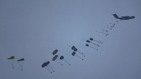 An aircraft airdrops humanitarian aid over Gaza the northern Gaza Strip, as seen from southern Israel, Friday, March 8, 2024