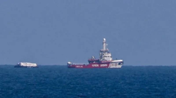 A ship towing 200 tons of aid is visible off the Gaza coast in a pilot voyage aimed at opening up a maritime route for aid