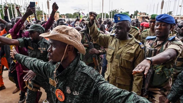 Niger's National Council for the Safeguard of the Homeland Col-Maj Amadou Abdramane, second from right, is greeted by supporters upon his arrival at the Stade General Seyni Kountche in Niamey on Aug. 6, 2023. — courtesy Getty Images