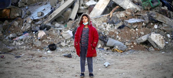 A twelve-year-old girl stands in front of her destroyed house in Rafah city, southern Gaza. — courtesy UNICEF/Eyad El Baba