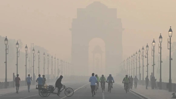 Morning walkers seen during a cold and hazy morning at Kartavya Path near India Gate on December 9, 2023 in New Delhi, India