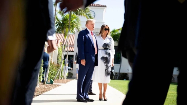 Donald and Melania Trump stand in front of members of the media after casting their votes at the Morton and Barbara Mandel Recreation Center on March 19, in Palm Beach, Florida