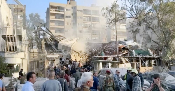 Rescuers sift through the rubble of the destroyed Iranian consulate in Syria following a deadly air strike.