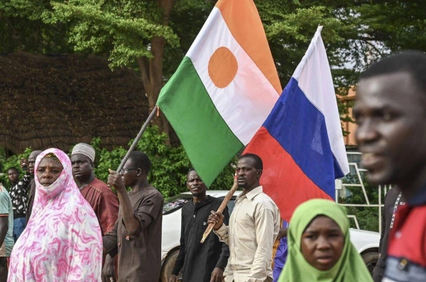 Supporters of Niger's National Council for Safeguard of the Homeland (CNSP) hold up Niger's national flag and the national flag of Russia at the General Seyni Kountche stadium in Niamey on Agust 26, 2023