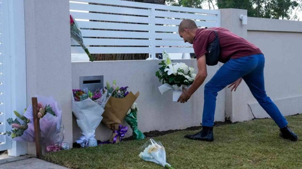 A man places flowers outside the Christ the Good Shepherd church in suburban Wakely in western Sydney, Australia, Tuesday, April 16, 2024