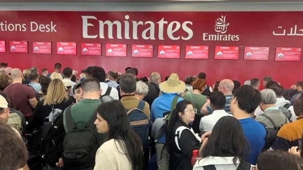 People queue at the flight connection desk the day after a storm swept across the UAE, causing flooding. — courtesy Reuters