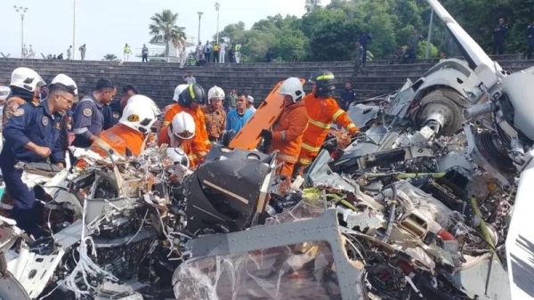 Rescue personnel removing debris from the helicopter