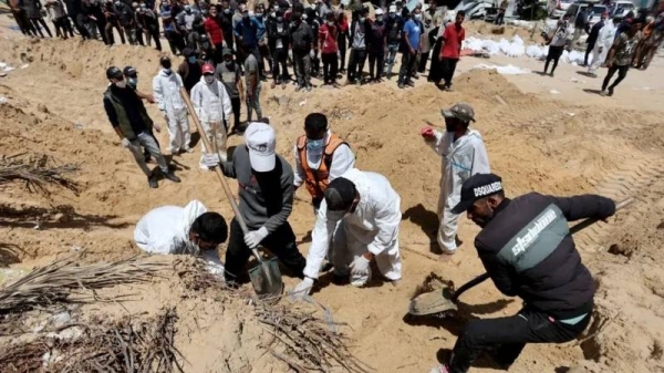 Palestinian workers are exhuming bodies at Nasser hospital with shovels because they have no heavy machinery