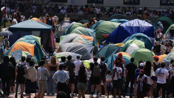 Columbia students march around their camp after the deadline passes