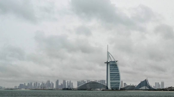 Thick clouds fill the sky above the Burj Al-Arab tower in Dubai on May 2, 2024, as heavy rains returned to the United Arab Emirates just two weeks after record downpours