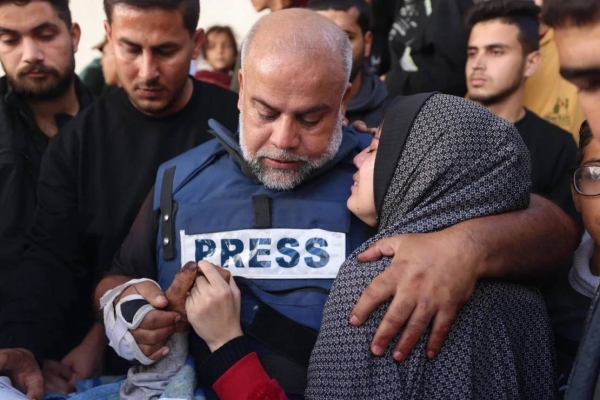 Al Jazeera's Gaza bureau chief Wael Al-Dahdouh (center) hugs his daughter during the funeral of his son, Hamza Al-Dahdouh, a reporter who was killed in an Israeli strike in southern Gaza, on January 7