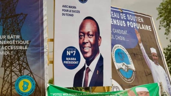 Candidate posters, including that of Succès Masra (C) and Mahamat Déby (R) can be seen in the capital