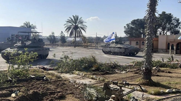 A photo provided by the Israel Defense Forces shows a tank with an Israel flag on it entering the Gazan side of the Rafah border crossing on Tuesday, May 7, 2024