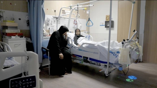 Sabha Al-Soury comforts her daughter Ola at the hospital in Doha. In addition to having lost members of their family, they worry about the fate of those still left behind