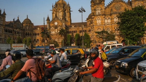 Commuters drive past the Chhatrapati Shivaji Terminus in Mumbai, India, on April 18, 2024