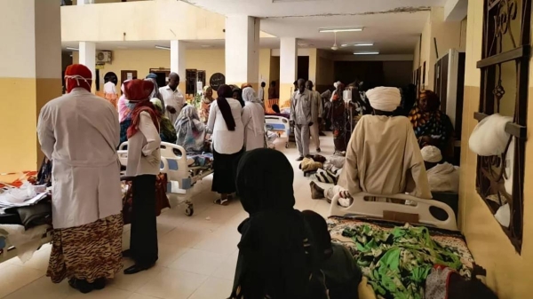 People wait to receive treatment at a hospital in El Fasher, Sudan, in May 2023