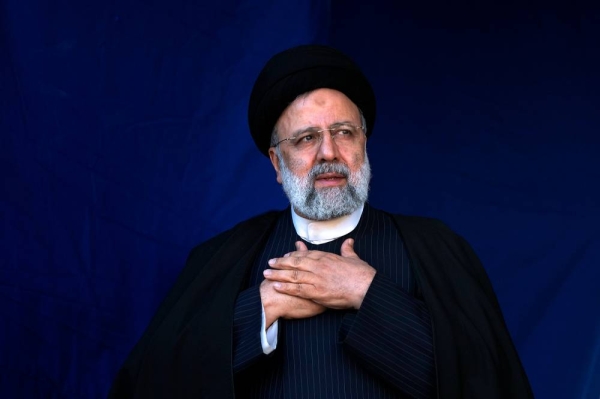 Iranian President Ebrahim Raisi places his hands on his heart as a gesture of respect to the crowd during the funeral ceremony of the victims of Wednesday's bomb explosion in the city of Kerman about 510 miles (820 kms) southeast of the capital Tehran, Iran, Friday, Jan. 5, 2024. Iran on Friday mourned those slain in an Islamic State group-claimed suicide bombing targeting a commemoration for a general slain in a U.S. drone strike in 2020, as the death toll in the attack rose to at least 89. (AP Photo/Vahid Salemi)