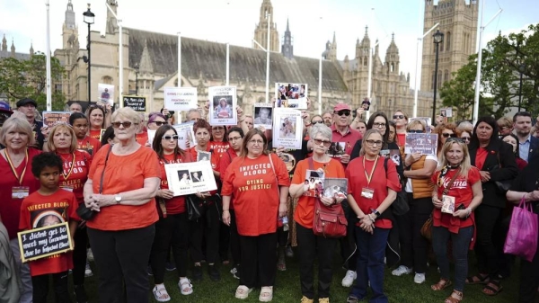 Infected blood campaigners gather in Parliament Square, ahead of the publication of the final report into the scandal, in London