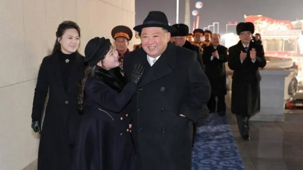 Kim Jong Un attends a military parade with his wife Ri Sol Ju (left) and their daughter Kim Ju Ae (center)