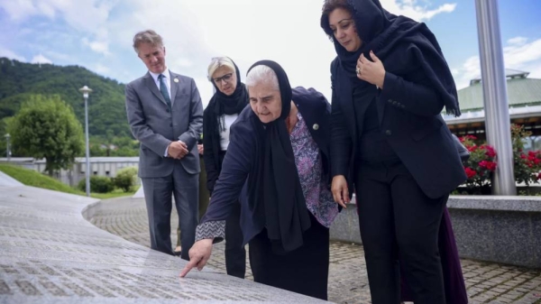 Nusrat Ghani walks with Munira Subasic next to the monument with the names of Srebrenica genocide victims in Potocari, Bosnia, on Wednesday, May 22, 2024.
