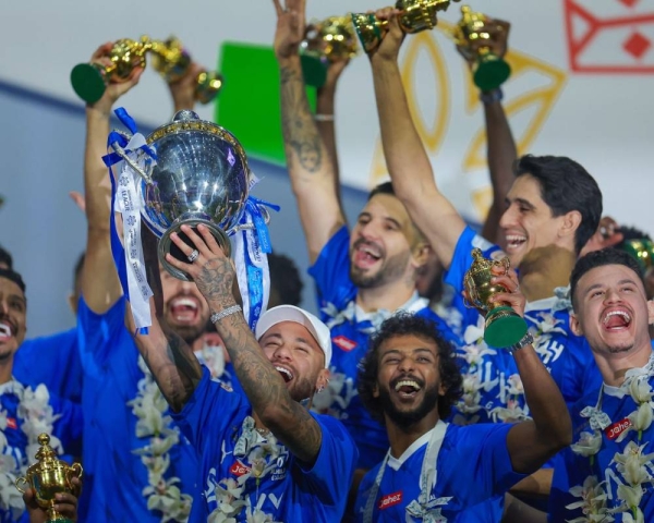 Neymar celebrates lifting the Saudi Pro League trophy with his teammates.
