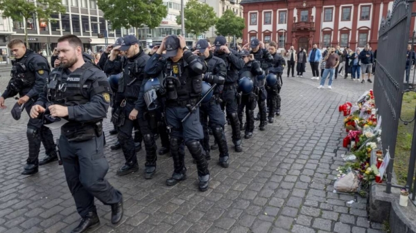 German police officers commemorate a colleague in Mannheim Germany, after learning that a police officer, who was stabbed two days ago there has died on Sunday, June 2, 2024
