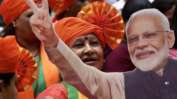 BJP supporters hold a cut-out of Prime Minister Modi, who is on track for a third term in a row