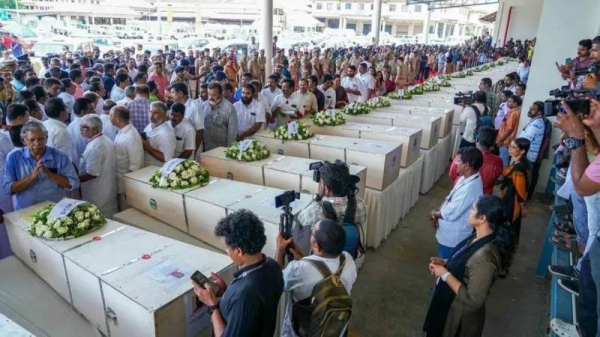 Relatives mourn as coffins arrive from Kuwait on an Indian Air Force plane at Kochi