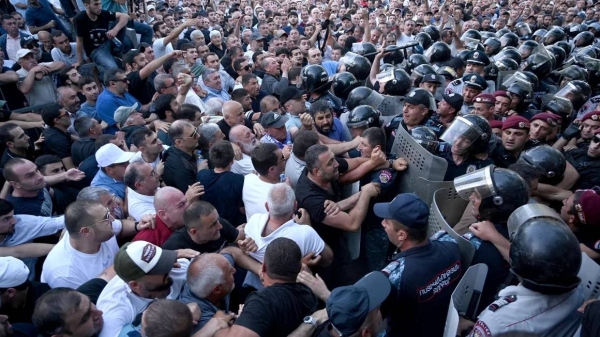 Anti-government protesters clash with police outside the parliament in Yerevan, Armenia, June 12, 2024