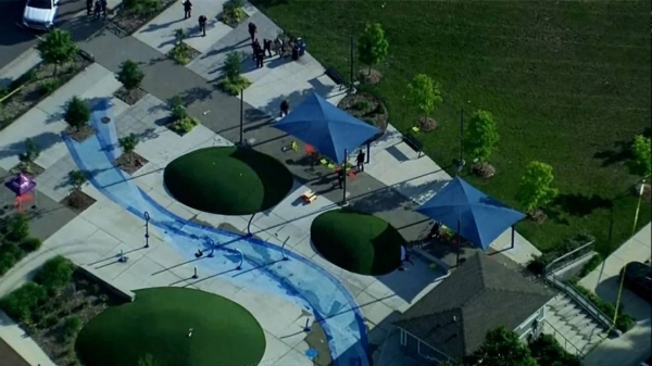 Police respond to the scene of a shooting at the Brooklands Plaza Splash Pad in Rochester Hills, Michigan, on Saturday.
