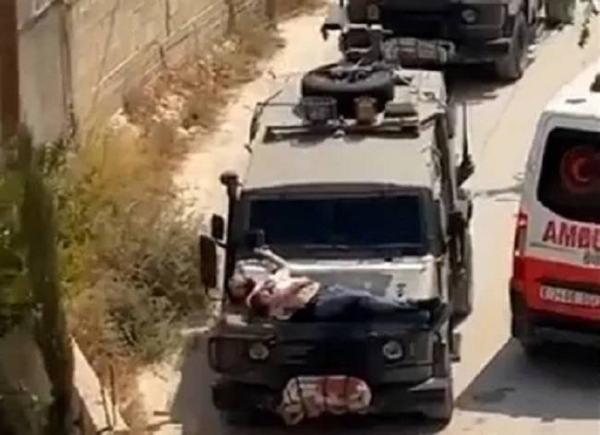 An injured Palestinian man is seen strapped to the hood of an Israeli military jeep in a video screengrab on June 22, 2024