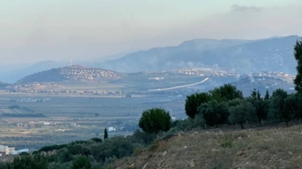 The town of Metula, Israel as seen from southern Lebanon. Smoke rises on the Lebanese side of the partition after an Israeli strike